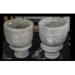 Two Mayan Urns - circular planter decorated with Aztec design on circular base.