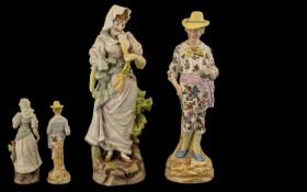 Pair of German Bisque Porcelain Figurines depicting a country gentleman in a floral suit and straw