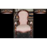 A Mahogany Victorian Style Spoon Back Arm Chair with carved back rest and front legs, a padded