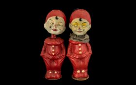 A Pair of Antique Bobbing Head Figures in the form of clowns. Constructed from paper mache,