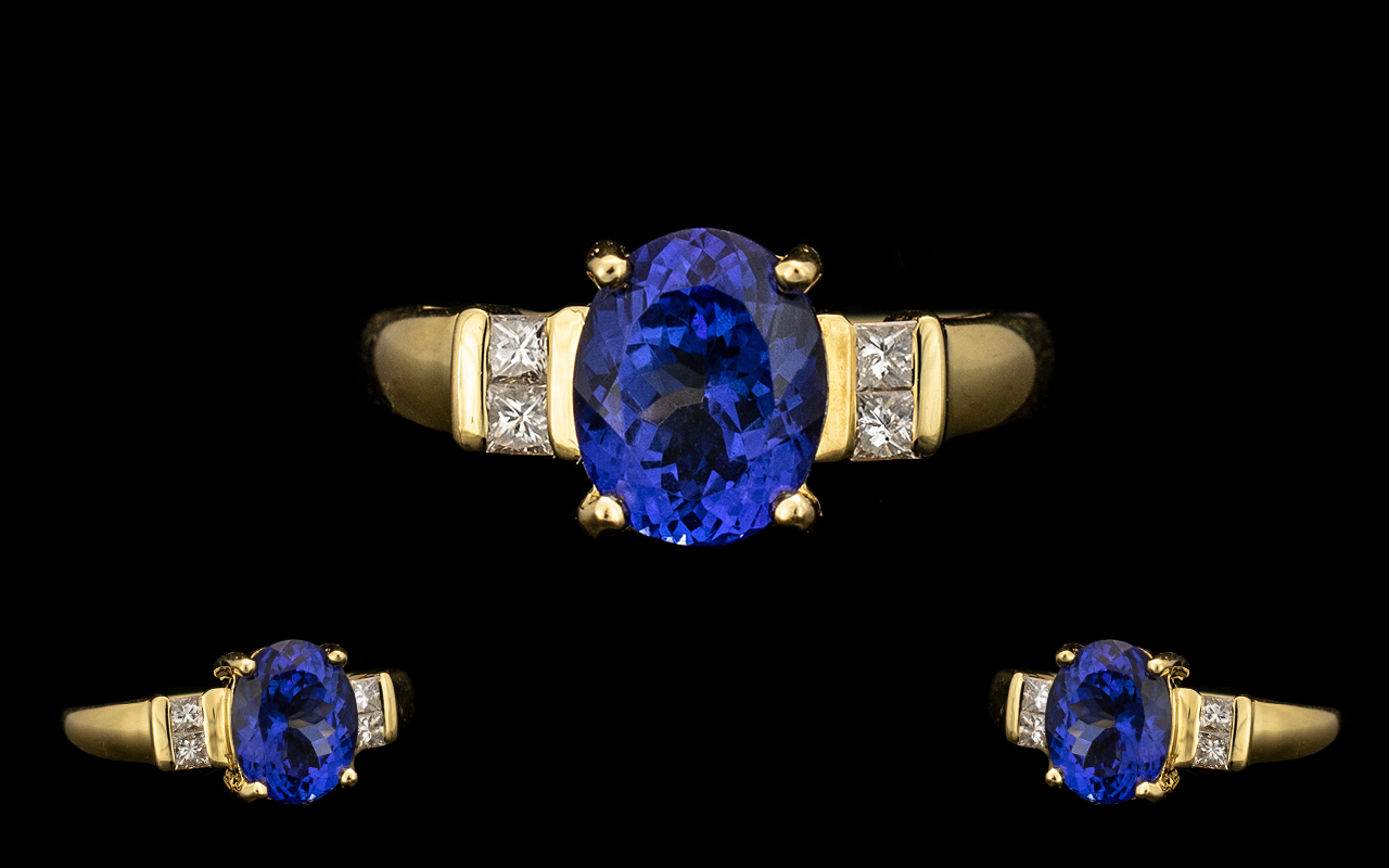 18ct Gold - Top Quality Tanzanite and Diamond Set Dress Ring. The central oval shaped Tanzanite of