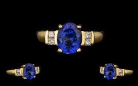 18ct Gold - Top Quality Tanzanite and Diamond Set Dress Ring. The central oval shaped Tanzanite of
