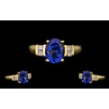 18ct Gold - Top Quality Tanzanite and Diamond Set Dress Ring. The central oval shaped Tanzanite of