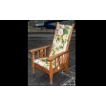 Child's Reclining Chair. Oak framed chair, with floral upholstery, raised on four legs. Height