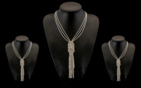 White Crystal Long Circle and Tassel Necklace, the full length of the necklace comprising three