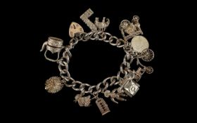 Silver Curb Bracelet Loaded with 11 Good Quality Silver Charms. All Marked for Silver. 90.9 grams