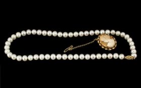 A Single Strand of Cultured Pearls with 14ct gold clasp. Length 16 inches. Together with a 9 ct