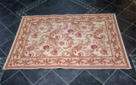 Laura Ashley Rug in wool with beige ground and pattern in dark coral and dark gold colours. Approx