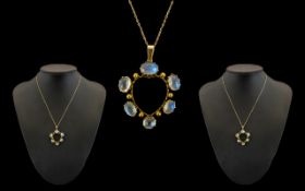 9ct Gold- Moonstone Set Circular Pendant of Attractive Form, Attached to a 9ct Gold Chain, Marked