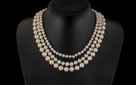 A Triple Strand Fresh Water Pearl Necklace length 17 inches. White metal clasp.