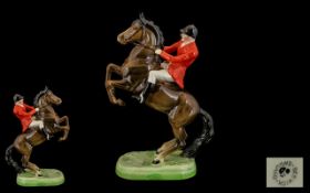 Beswick Horse & Rider Painted Figure. Red jacket Huntsman seated on rearing horse. Model No. 868.