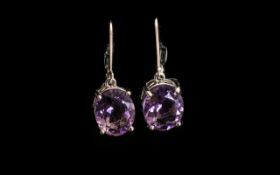 Amethyst Solitaire Drop Earrings, oval cut solitaires of dark purple amethyst, totalling 6.5cts, set