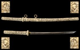 Japanese Samuri Sword with a carved bone handle and scabbard. Depicting Figures in various scenes,