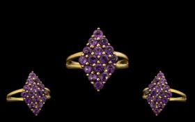 Ladies 9ct Gold Attractive Amethyst Set Dress Ring of Pleasing Form. Marked with Full Hallmark for