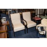 A Pair of Lounge Chairs dark wood frame with beige upholstery, removable cushioned seat and scroll