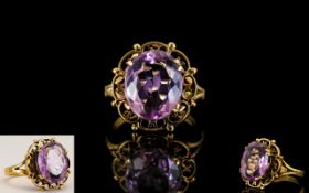 Ladies 9ct Gold Attractive Single Stone Amethyst Set Dress Ring - with open worked setting. Marked