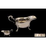 A Solid Silver Sauce Boat with Shaped Bo