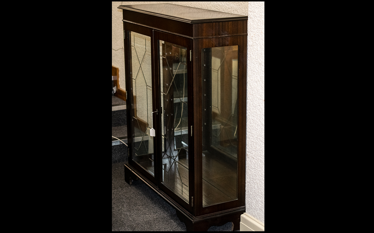 Dark Wood Glass Front Display Cabinet with glass shelves and lights, and mirrored interior. In
