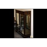Dark Wood Glass Front Display Cabinet with glass shelves and lights, and mirrored interior. In