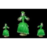 Murano Glass 'Elegant Lady' wearing a green dress and matching hat, on a swirling gilt base. circa