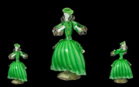 Murano Glass 'Elegant Lady' wearing a green dress and matching hat, on a swirling gilt base. circa