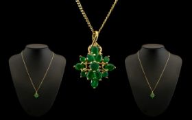 9ct Gold Starburst Design Pendant set with emeralds. Attached to a long 9ct gold chain. Both pendant