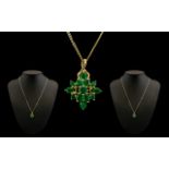 9ct Gold Starburst Design Pendant set with emeralds. Attached to a long 9ct gold chain. Both pendant