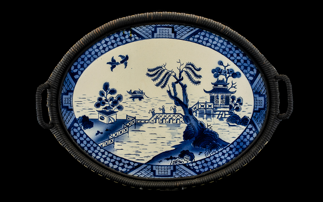 An Early 20thC Twin Handled Tray with a blue and white ceramic plaque, blue and white pagoda pattern