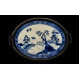 An Early 20thC Twin Handled Tray with a blue and white ceramic plaque, blue and white pagoda pattern