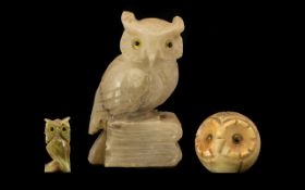 Collection of Three Owl Figures comprising an Onyx owl figure raised on a base with glass eyes,