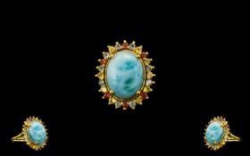 Green, Yellow and Sunset Sapphire Haloed Larimar Ring, a 10ct cabochon of the natural, opaque,