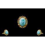 Green, Yellow and Sunset Sapphire Haloed Larimar Ring, a 10ct cabochon of the natural, opaque,