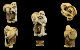 Japanese - Mid 19th Century Signed Well Carved Ivory Netsuke Depicts a Male Figure Carrying a