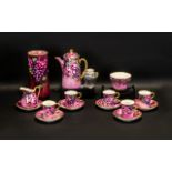 A Royal Doulton Part Coffee Set, handpainted in pretty pink floral and grape design, with gilt