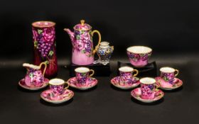 A Royal Doulton Part Coffee Set, handpainted in pretty pink floral and grape design, with gilt