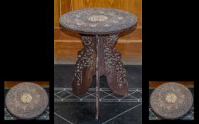 A Carved Indian Tripod Table with pierced leaf decorated support. The top with bone inlay and leaf