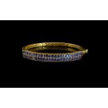 Tanzanite Double Row Hinged Bangle, two rows of oval cut tanzanites, totalling 9cts, set