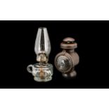 Two Oil Lamps to include a clear faceted Queen Anne oil lamp and a Railway lamp. 11 and 9 inches