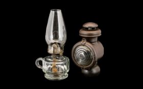 Two Oil Lamps to include a clear faceted Queen Anne oil lamp and a Railway lamp. 11 and 9 inches