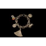 Art Nouveau Silver Stylised Bracelet loaded with 6 silver charms, the feature being the detailed fan