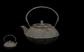 An Antique Japanese Cast Iron Tea Kettle with a moulded dotted body Meiji period character marks