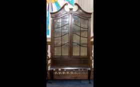 An Edwardian Mahogany Inlaid Display Cabinet - broken pediment above shaped astral glazed door.