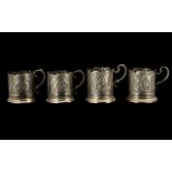 A Set of Four Antique Mogul/Indian Silvered Metal Embossed Tea Glass Holders decorated to the body