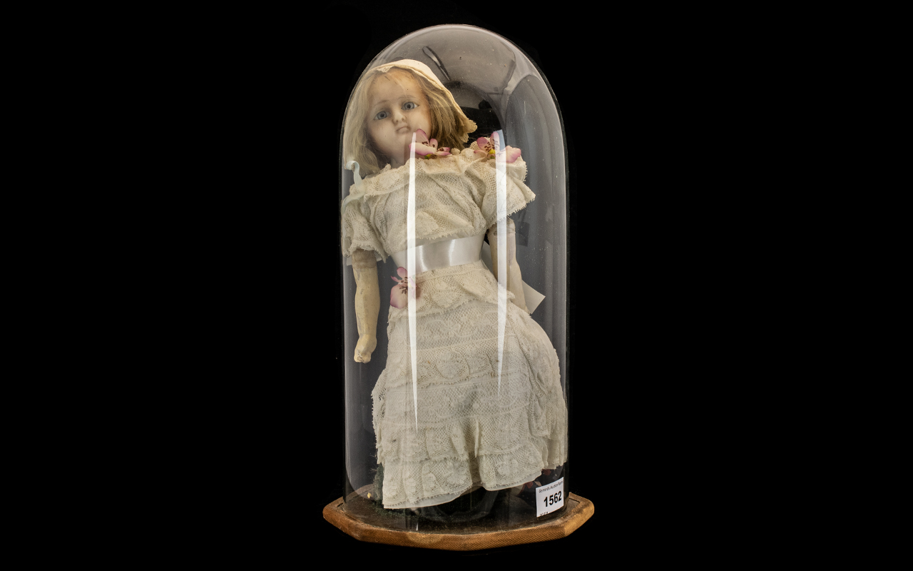 Antique Wax Faced Doll in Glass Globe. Doll has wooden arms and legs, and is dressed in a lace