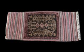 A Turkish Woven Wool Carpet burgundy an