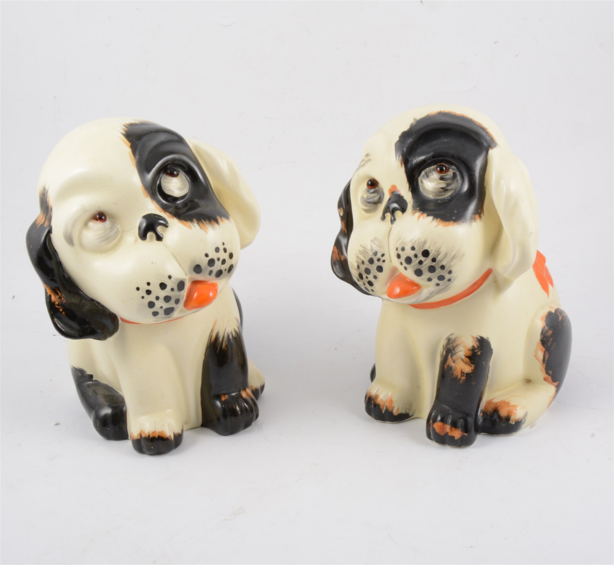 Seven Crown Devon "Perky Puppy" figures, five with glass eyes, two 23cm doorstop figures, one