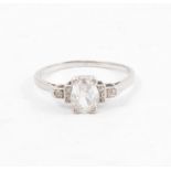 A diamond solitaire ring, the oval old cut diamond four claw set with three small diamonds in each