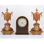 An Edwardian dome cased mantel clock, W Payne & Co, and two gilt garniture