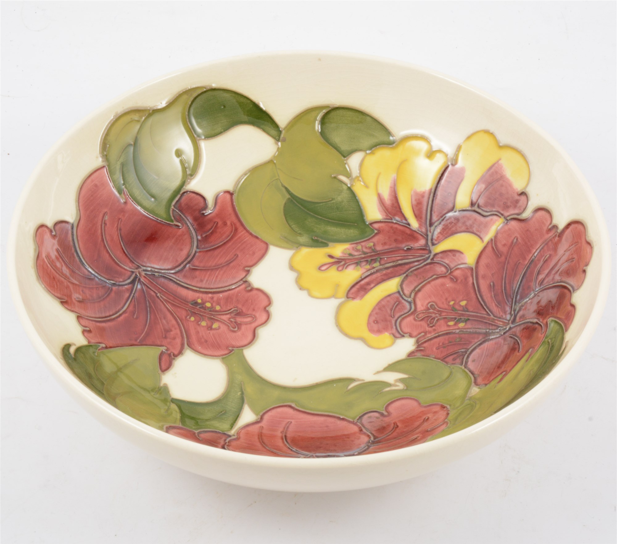 A Moorcroft bowl in the "Hibiscus" design on cream ground, 26cm diameter.