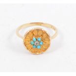 A floral design turquoise dress ring with six small turquoise and a small diamond to centre, shank